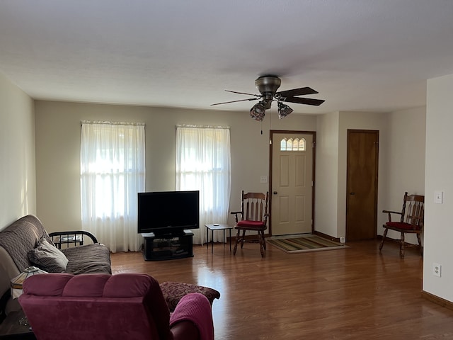 living room with hardwood / wood-style floors and ceiling fan