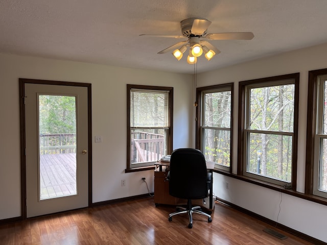 office featuring ceiling fan, a textured ceiling, and dark hardwood / wood-style flooring