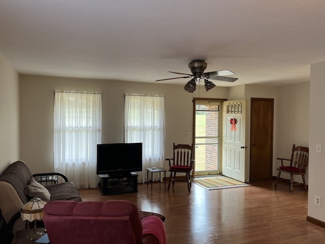 living room with wood-type flooring and ceiling fan