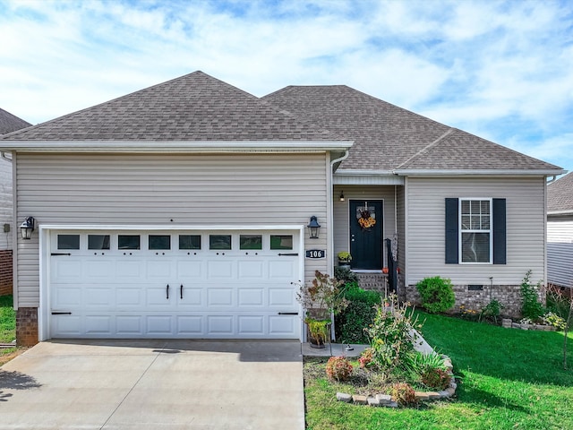 view of front of home featuring a garage and a front yard