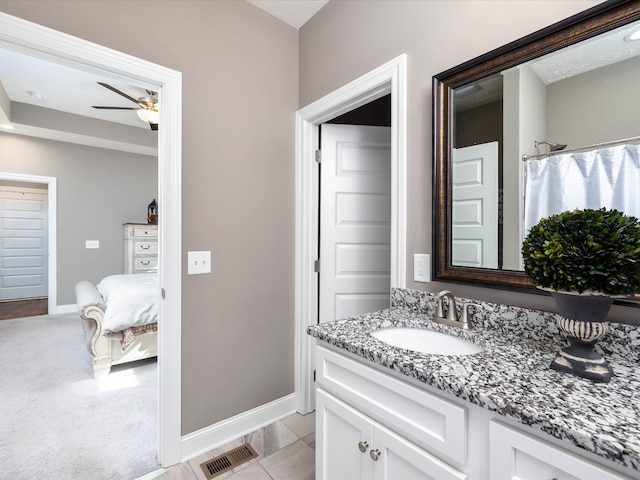 bathroom with tile patterned flooring, a shower with curtain, ceiling fan, a textured ceiling, and vanity