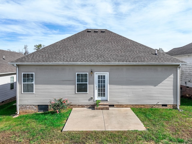 back of property with a patio area and a lawn