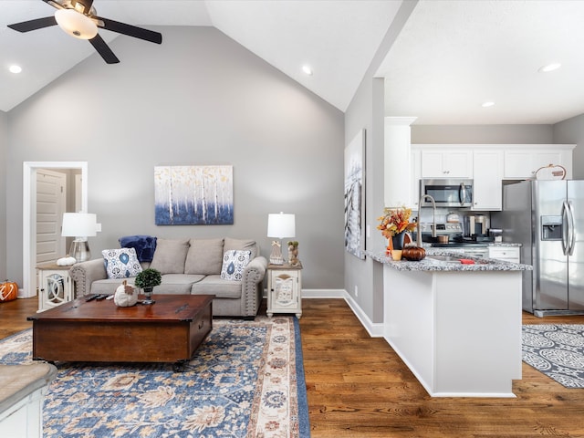 living room featuring high vaulted ceiling, dark hardwood / wood-style flooring, and ceiling fan