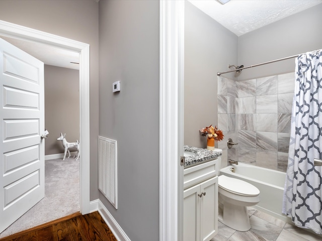 full bathroom with hardwood / wood-style flooring, vanity, shower / bath combo with shower curtain, and toilet