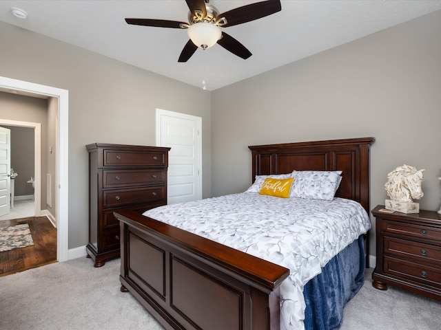 bedroom with light carpet and ceiling fan