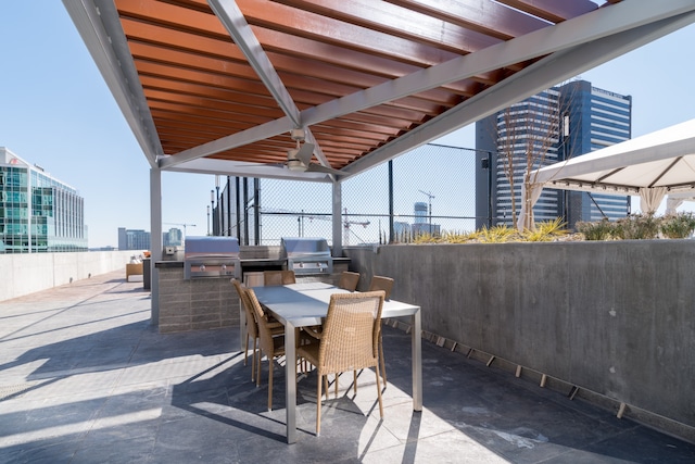 view of patio / terrace with area for grilling, an outdoor kitchen, and ceiling fan