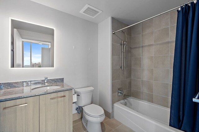 full bathroom with toilet, vanity, shower / bath combination with curtain, and tile patterned flooring