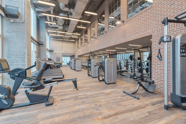 workout area featuring hardwood / wood-style flooring and a high ceiling