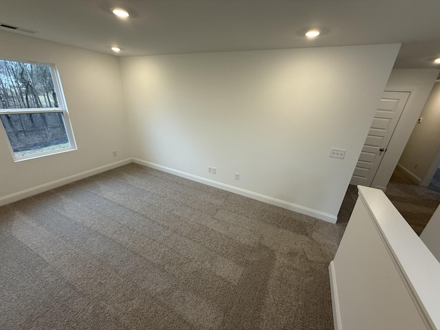 empty room featuring dark carpet