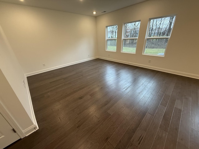 unfurnished room featuring dark hardwood / wood-style floors