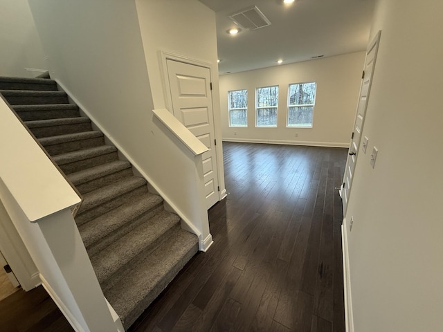 staircase with hardwood / wood-style floors