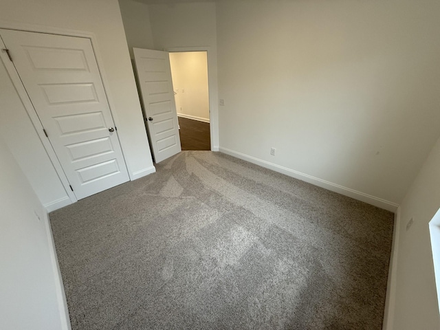 unfurnished bedroom featuring carpet floors and a closet