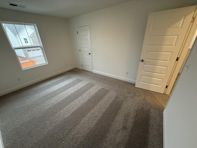 unfurnished bedroom featuring dark colored carpet