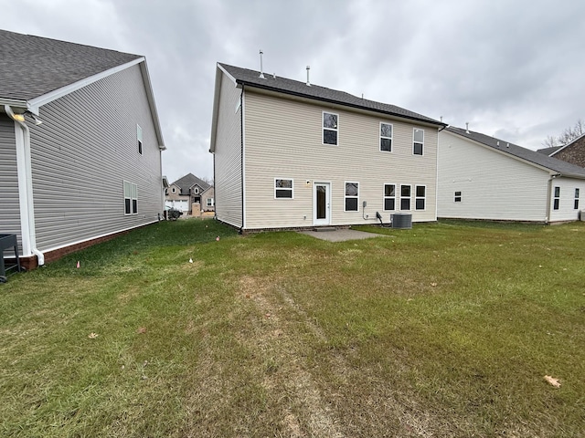 back of house featuring a patio area and a yard