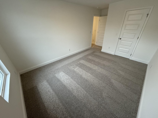 unfurnished bedroom with carpet floors and a closet