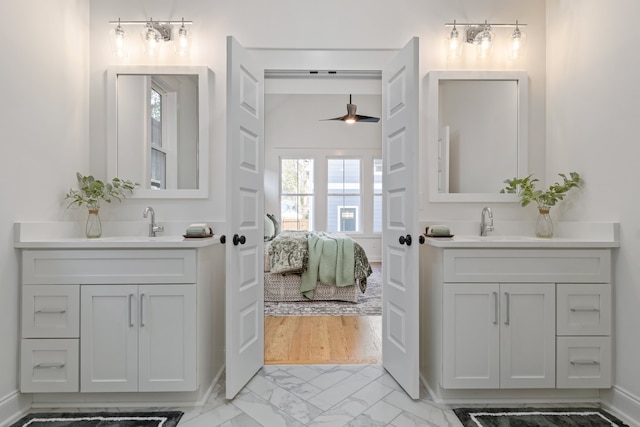 bathroom featuring hardwood / wood-style floors, ceiling fan, and vanity