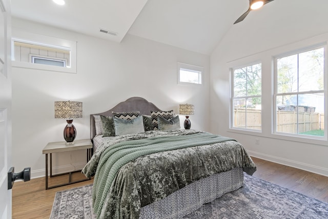 bedroom with hardwood / wood-style floors, ceiling fan, and vaulted ceiling