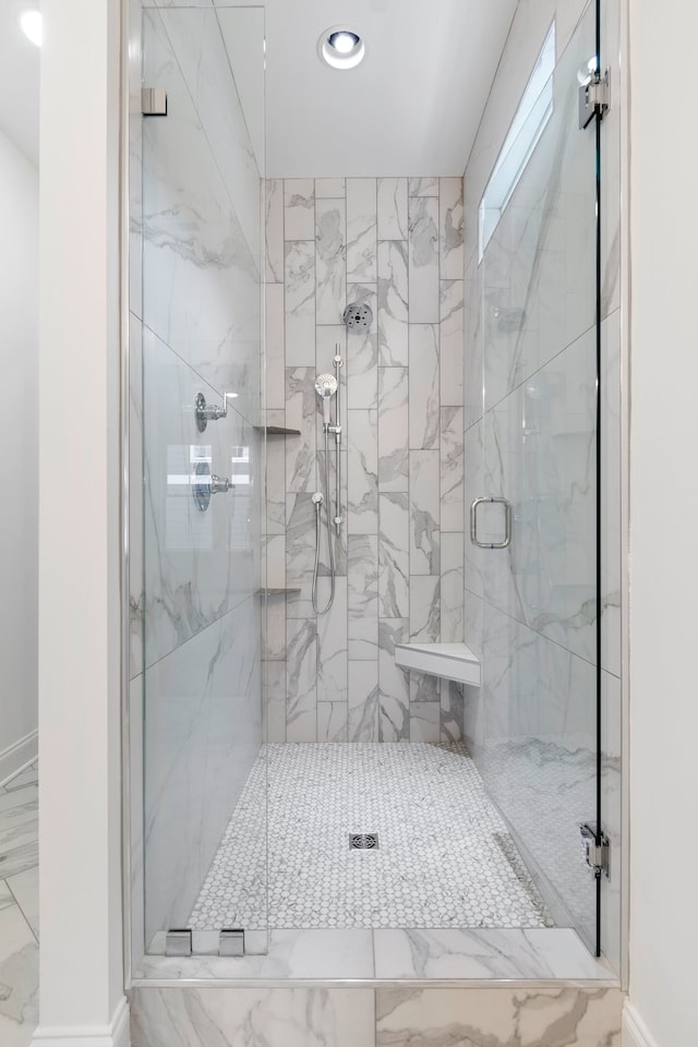 bathroom with a shower with door