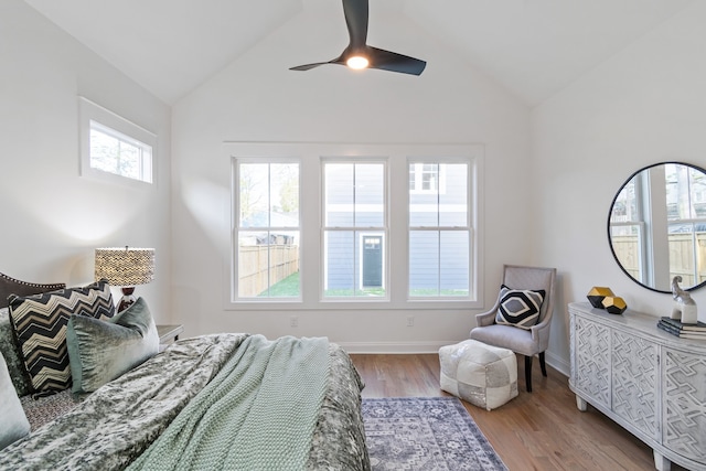 bedroom with light hardwood / wood-style floors, ceiling fan, and lofted ceiling