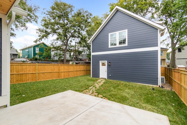 back of house with a patio area and a yard