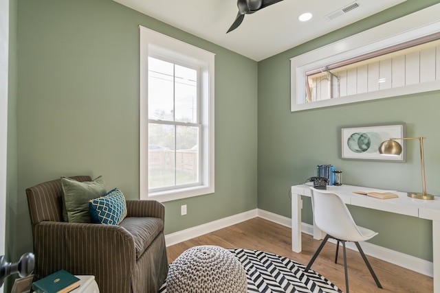 office space featuring ceiling fan and light hardwood / wood-style floors