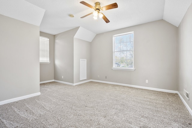 bonus room featuring a textured ceiling, ceiling fan, lofted ceiling, and carpet floors