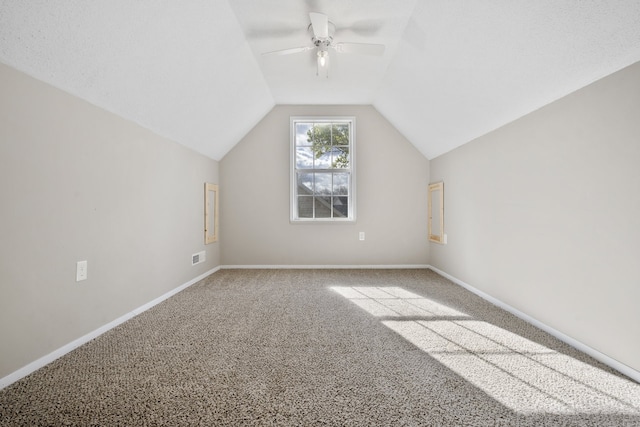 additional living space featuring ceiling fan, lofted ceiling, and carpet floors