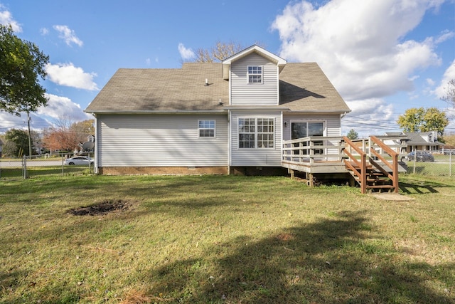 back of house with a lawn and a deck