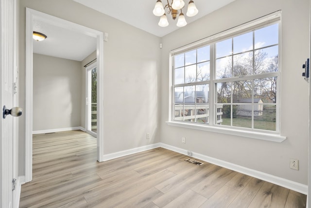 interior space featuring a chandelier and light wood-type flooring