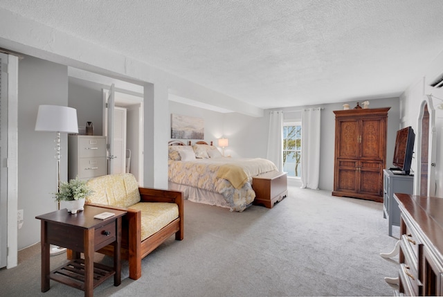 carpeted bedroom featuring a textured ceiling