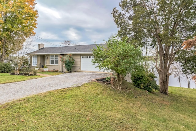 ranch-style home with a garage and a front lawn