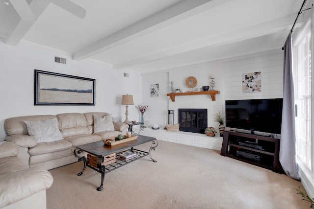 living room featuring carpet, plenty of natural light, and beam ceiling