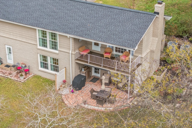 back of property with a patio and a yard