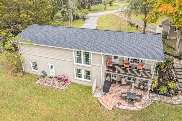 back of house with a yard and a patio