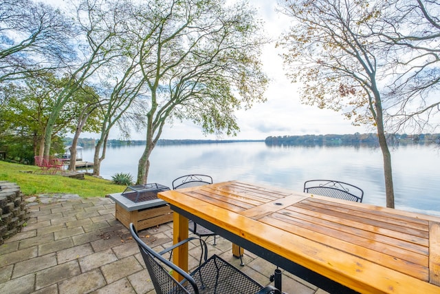 view of dock with an outdoor fire pit and a water view