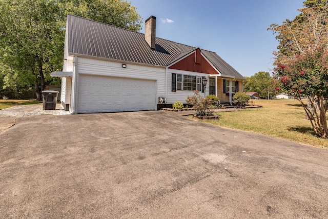 view of front of home with a garage and a front lawn