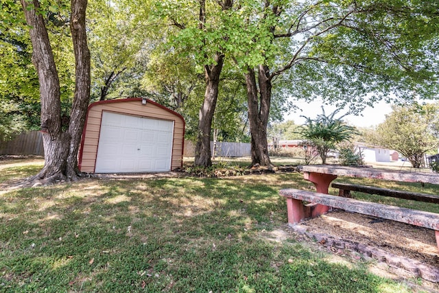 view of yard with a garage and an outdoor structure