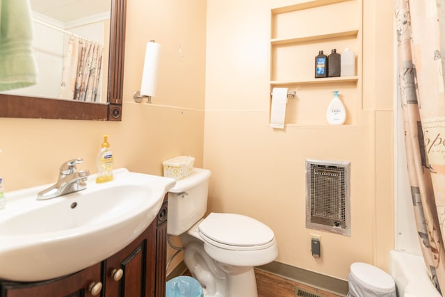 full bathroom featuring heating unit, wood-type flooring, vanity, shower / bath combo, and toilet