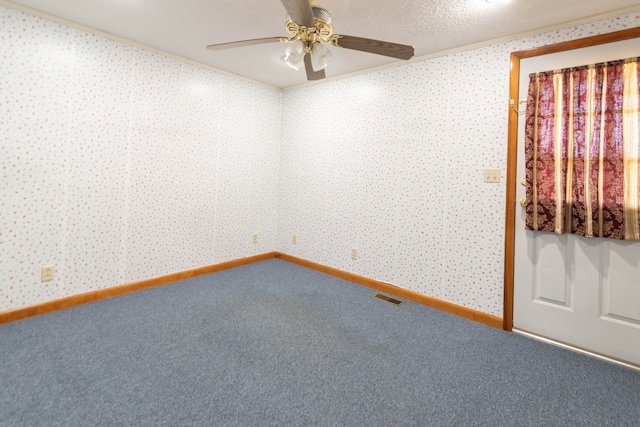 unfurnished room with a textured ceiling, carpet flooring, ceiling fan, and crown molding