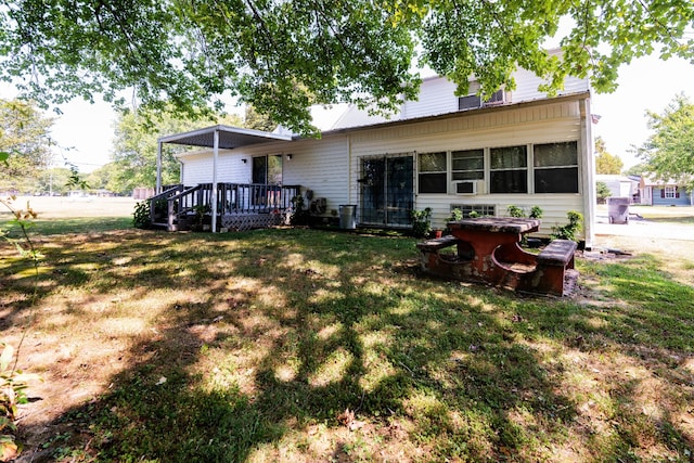 rear view of property with a lawn and a deck