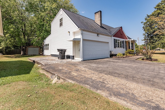 view of property exterior with a garage and a yard