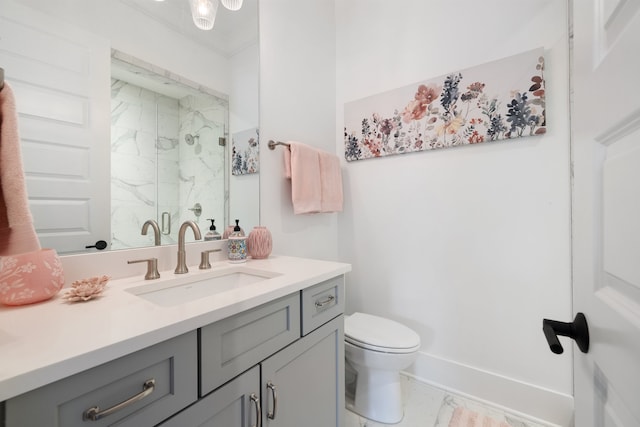 bathroom with a shower with shower door, vanity, and toilet