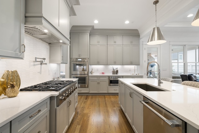 kitchen featuring gray cabinets, dark wood-type flooring, premium range hood, and stainless steel appliances