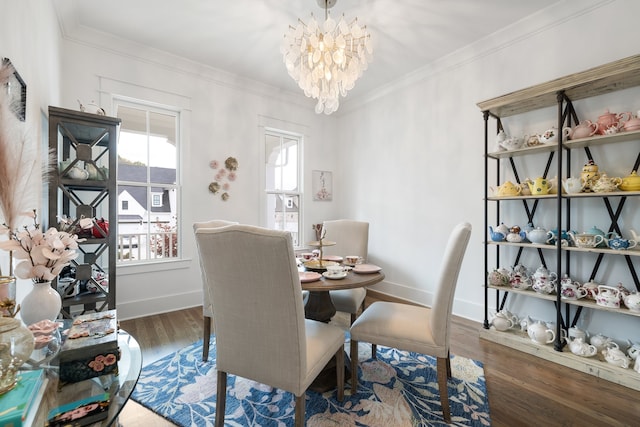 dining area with a chandelier, crown molding, and dark hardwood / wood-style flooring