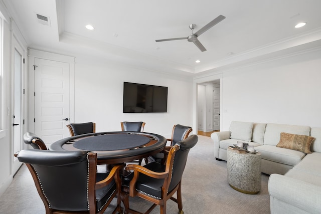 playroom featuring ornamental molding, a tray ceiling, carpet, and ceiling fan