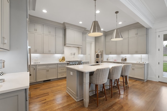 kitchen featuring gray cabinetry, dark hardwood / wood-style flooring, and crown molding