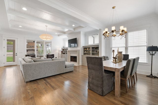 dining space with beamed ceiling, wood-type flooring, an inviting chandelier, and ornamental molding