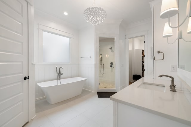 bathroom with tile patterned flooring, ornamental molding, a chandelier, vanity, and separate shower and tub