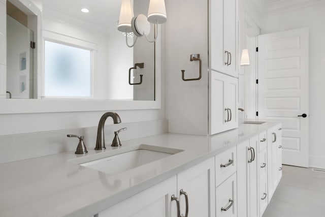 bathroom with ornamental molding, vanity, and tile patterned floors