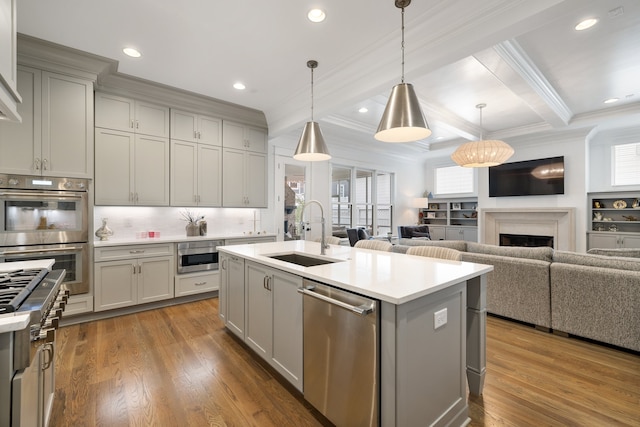 kitchen with a wealth of natural light, decorative light fixtures, and stainless steel appliances